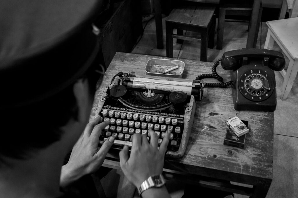 analogue phone and typewriter on table