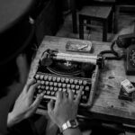 analogue phone and typewriter on table